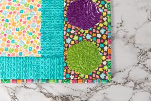 closeup view of cupcake-embroidered vinyl in green and purple