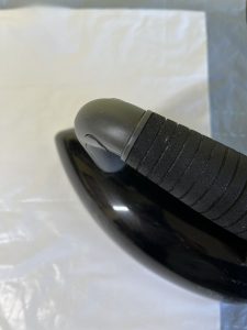 Close-up view of black dry iron pressing Shape-Flex to vinyl