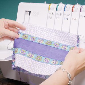 Hands turning the fabric right-side out after seaming.