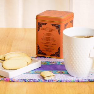 Close up of a tea mug and cookies on the finished snack mat.