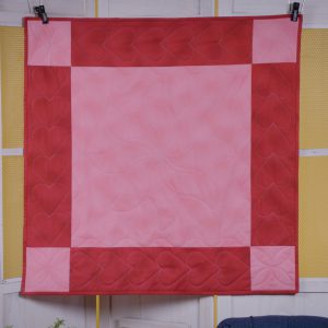 Overhead view of finished red and pink checkered table topper