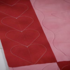 Up-close view of finished heart boarder on quilt