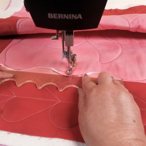 Ruler aligned with the seam line on pink and red checkered table topper