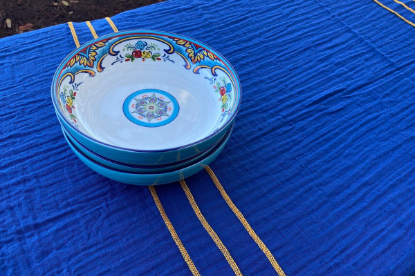 Blue tablecloth with gold seams and glass bowls on top