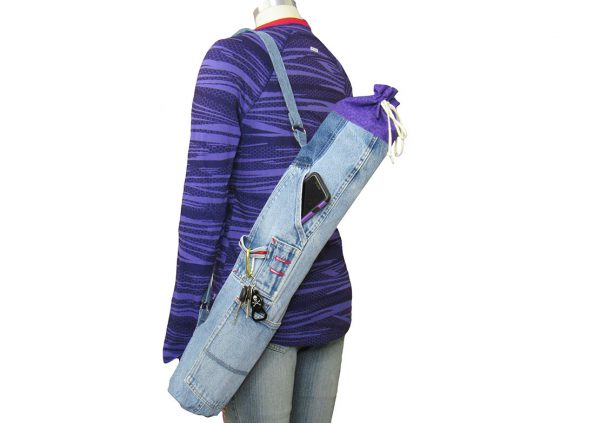Manikin wearing purple shirt and jeans with yoga bag crossed over body