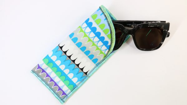 Sunglasses partially inside of multi-colored eyeglass case