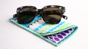 Sunglasses on top of multi-colored eyeglass case