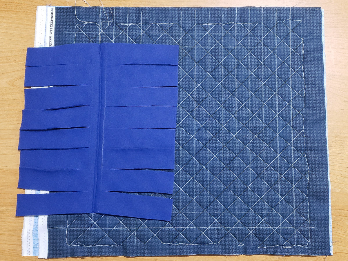 blue fleece attached to quilted fabric square