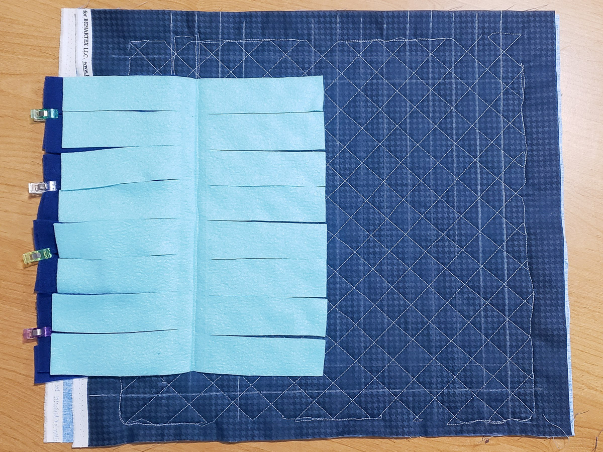 a second fleece rectangle sewn to a quilted fabric square