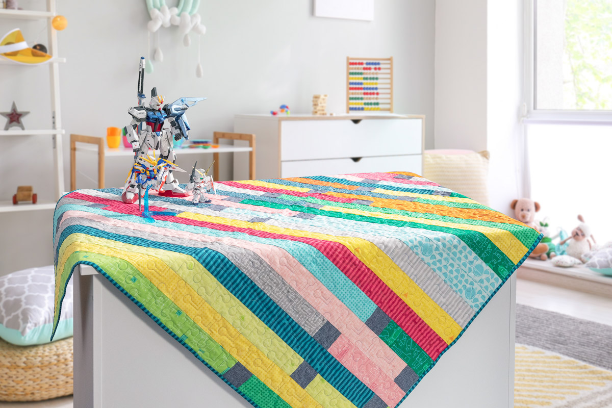 Colorful quilt arranged on a nursery table