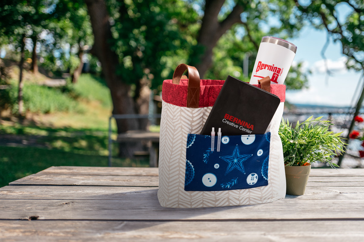 Blue fabric with white buttons and stars added to a tote bag