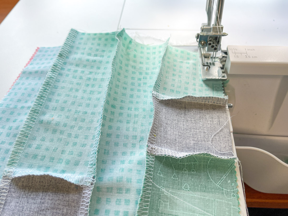 Various colors and lengths of fabric being serged