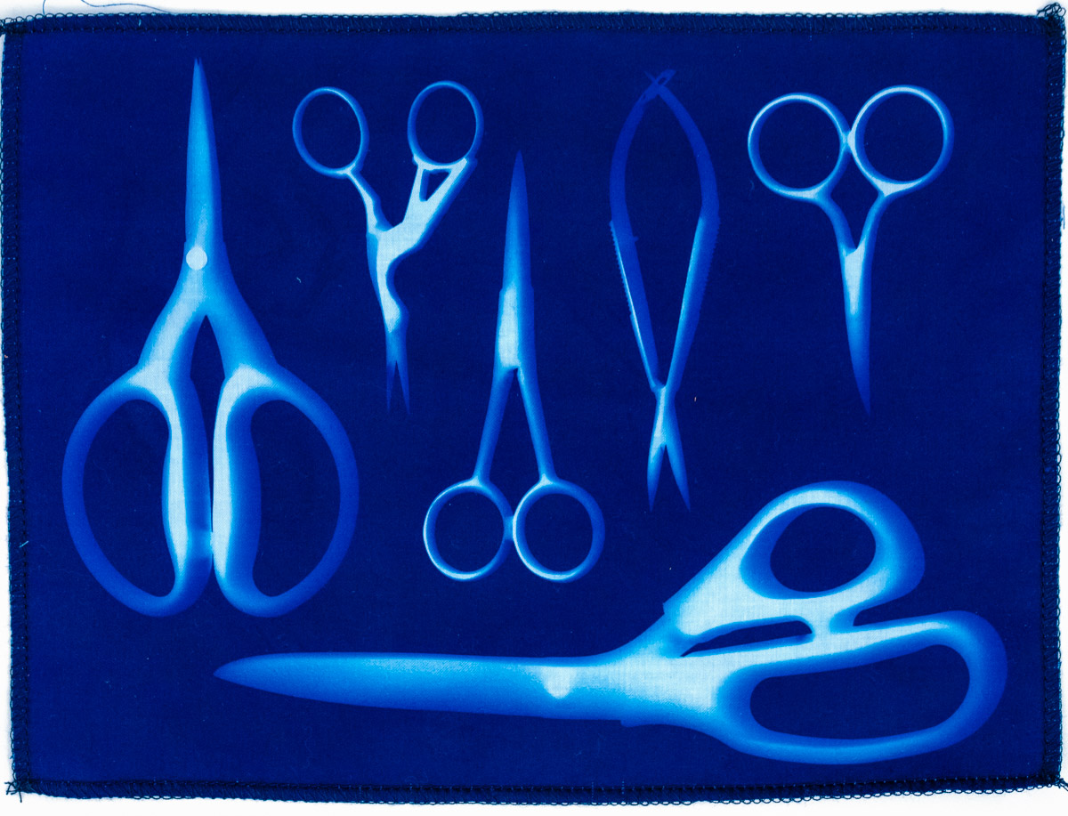 Scissors final result showcasing white imprints on a brilliant blue fabric