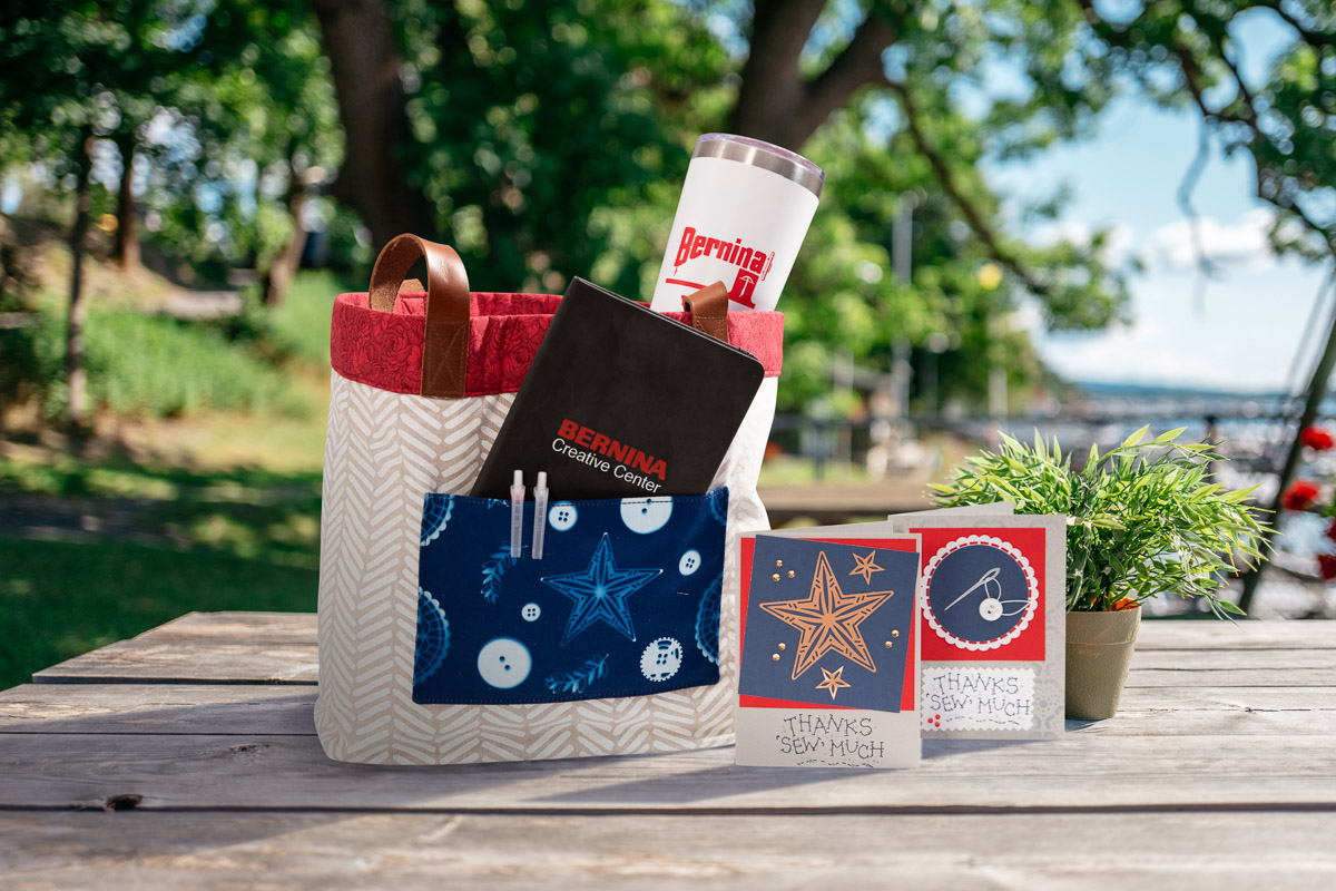 Beach-Bound Straw Tote using cyanotype fabric and arranged on a picnic table outside.