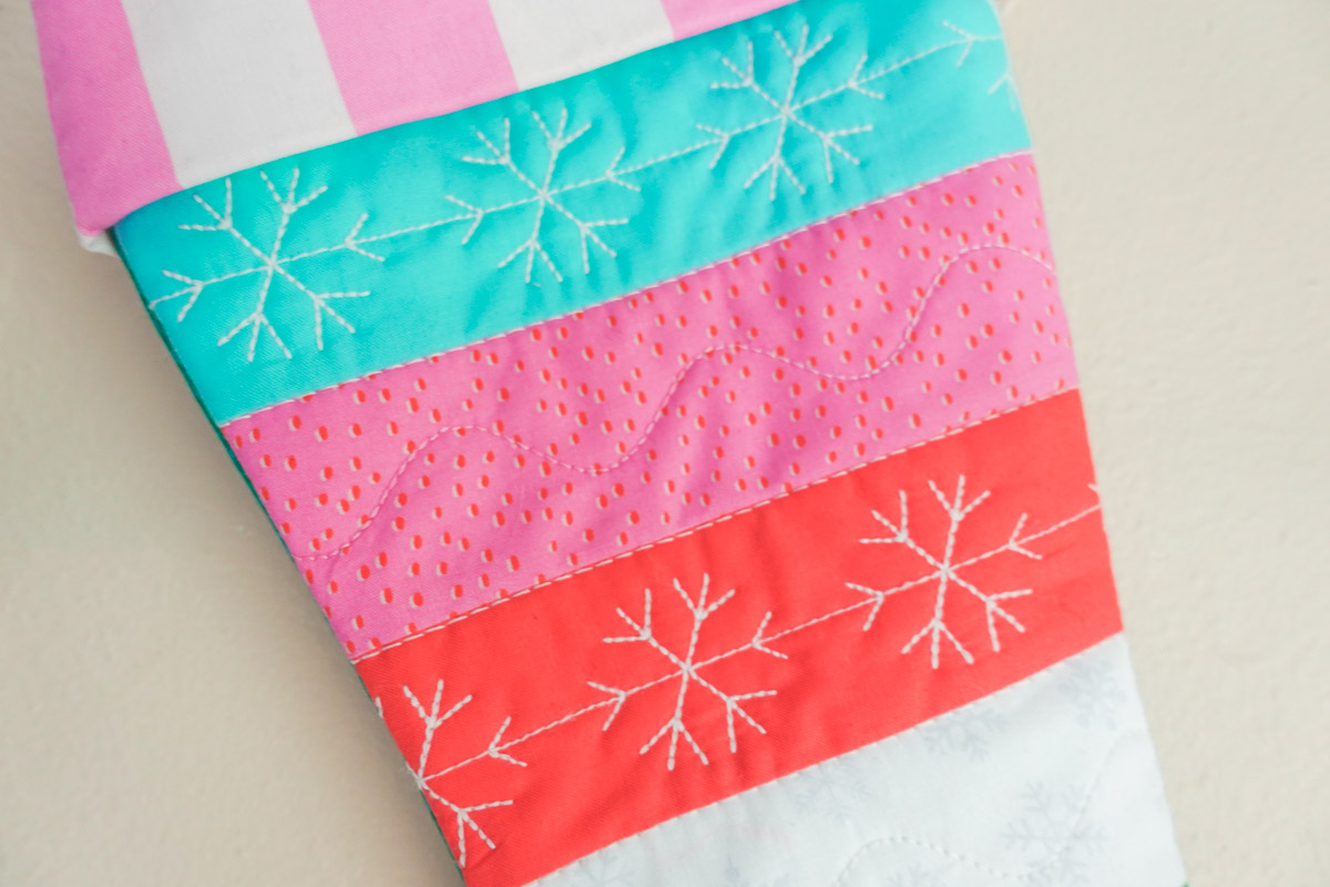 Blue, red, pink, and green quilted stocking close-up 