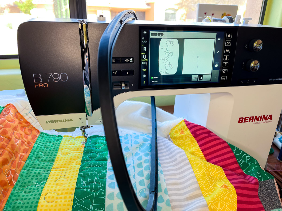 Front view of the B 790 PRO with quilt and an embroidery hoop