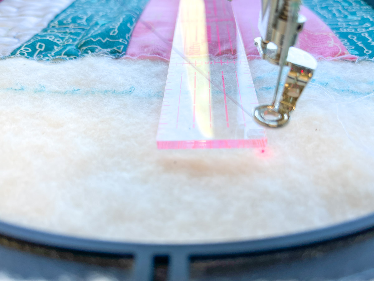 Closeup view of a ruler and the pintpoint laser on batting