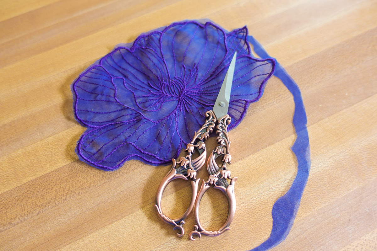 Snipping excess fabric and thread from an embroidered flower