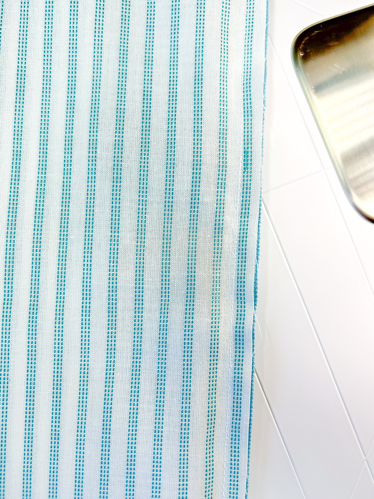 White stitched seam on striped fabric