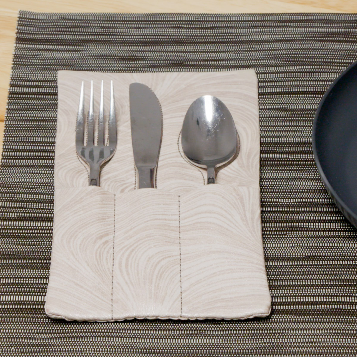 Cream silverware holder on a table setting