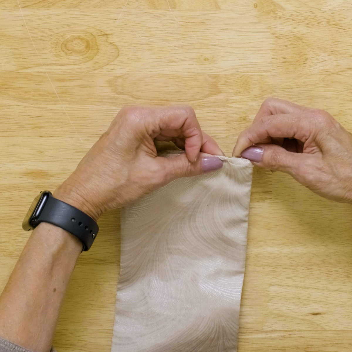 working a slipstitch seam along the edge of the fabric to close the turning gap