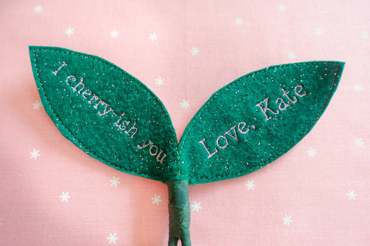 close up of the text on the machine embroidered cherry valentines on the B 990