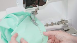 stitching on foam green fabric with the L 890, using the coverstitch hemmer