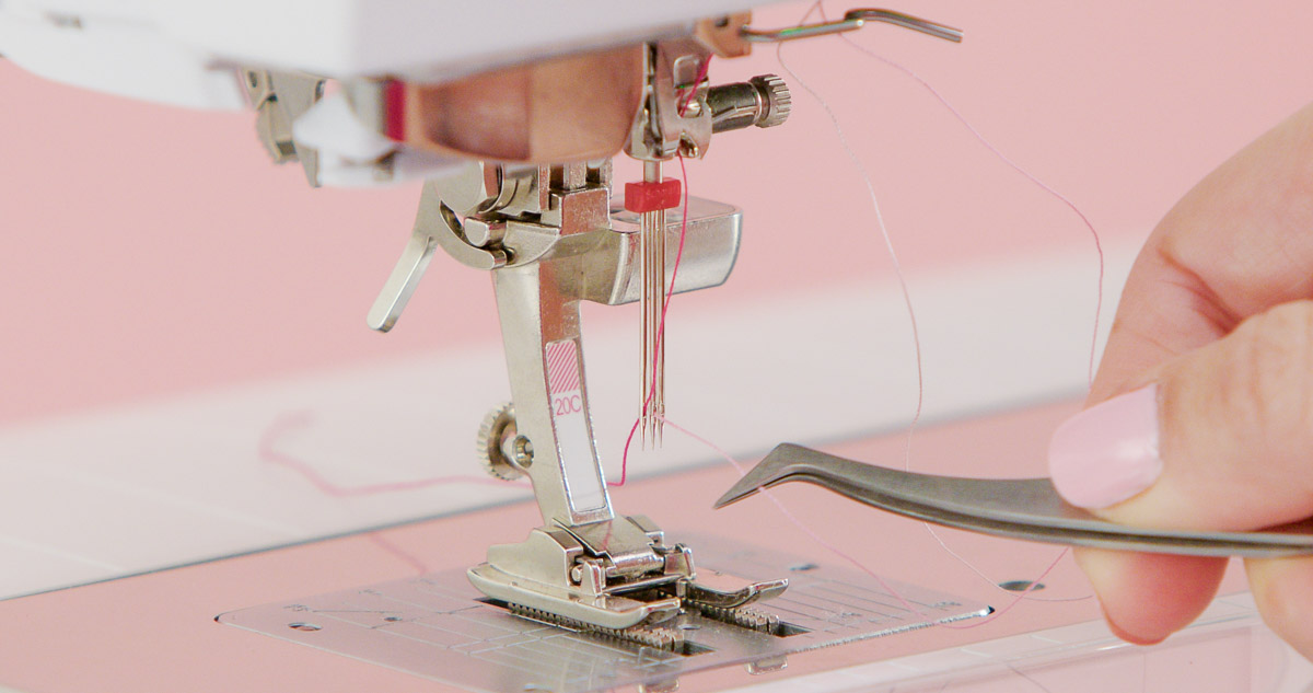 Threading the needle with tweezers