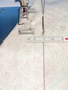 Sewing parallel lines on white fleece