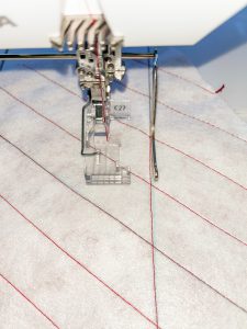 Sewing parallel lines on white fleece