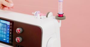 Two spools and one bobbin on spool holders