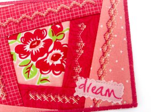 Close-up of fabric postcard with dream