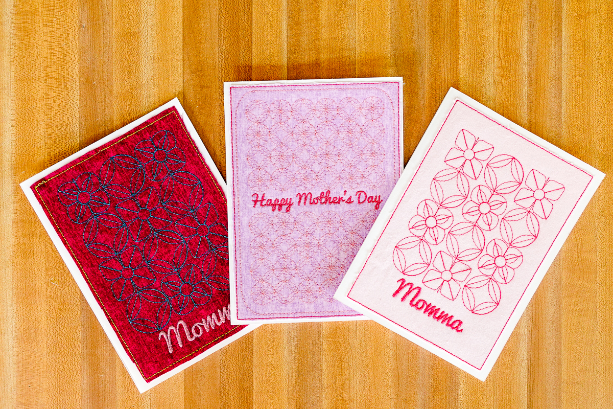 Three embroidered Mother’s Day Card variations on a wood backdrop