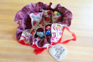 A handsewn DND dice bag with dice inside