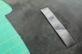 A close up image of a single welt pocket made in leather.