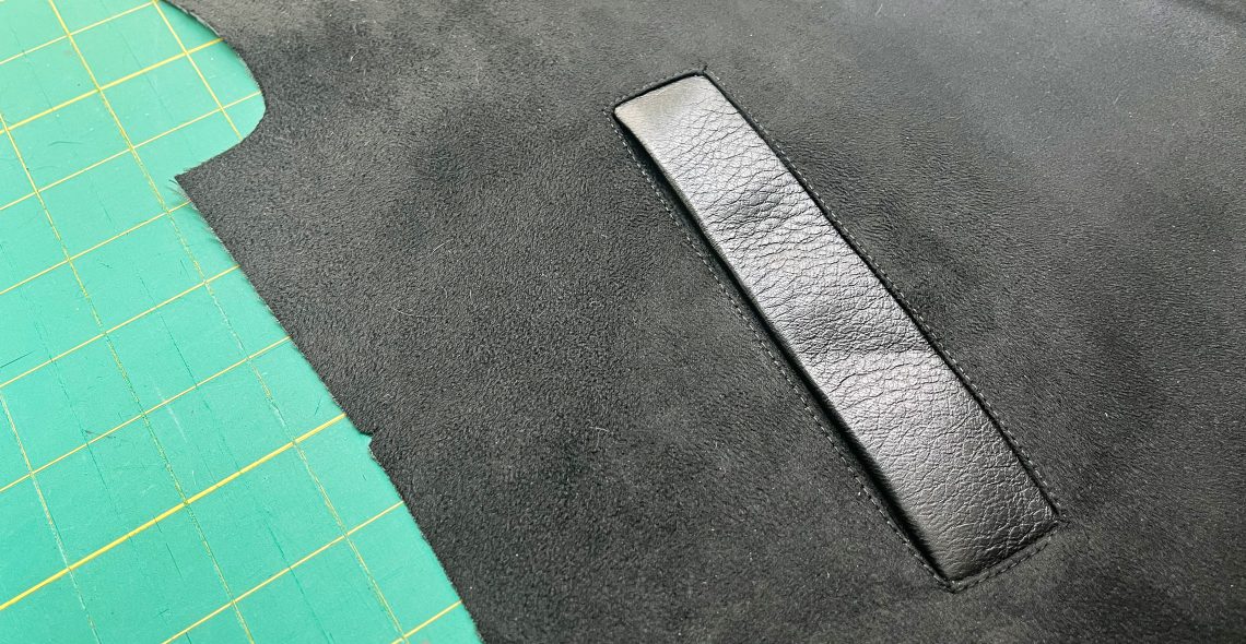 A close up image of a single welt pocket made in leather.