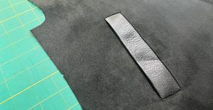 A close up image of a single welt pocket made in leather.