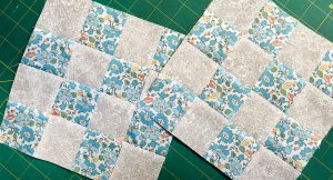 Two 16-patch quilt blocks layered on top of each other.