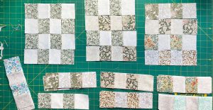 A flatlay image of in-progress 16-patch quilt blocks