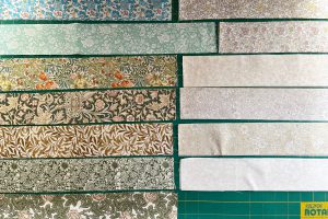 2.5" width strips of fabric cut in preparation for strip piecing.