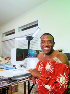 Black man sitting in front of a BERNINA B 790 Sewing Machine