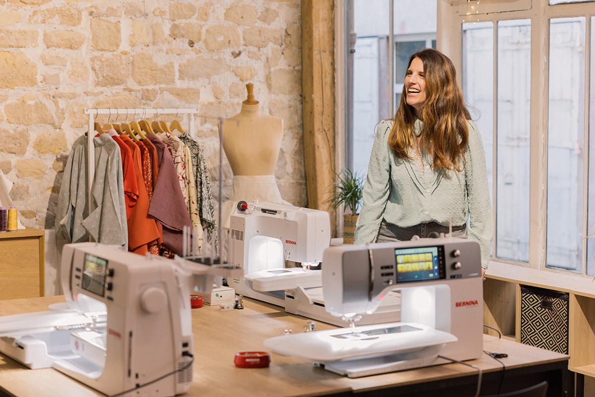 B 790 PRO sewing machine with embroidery module on an orange background
