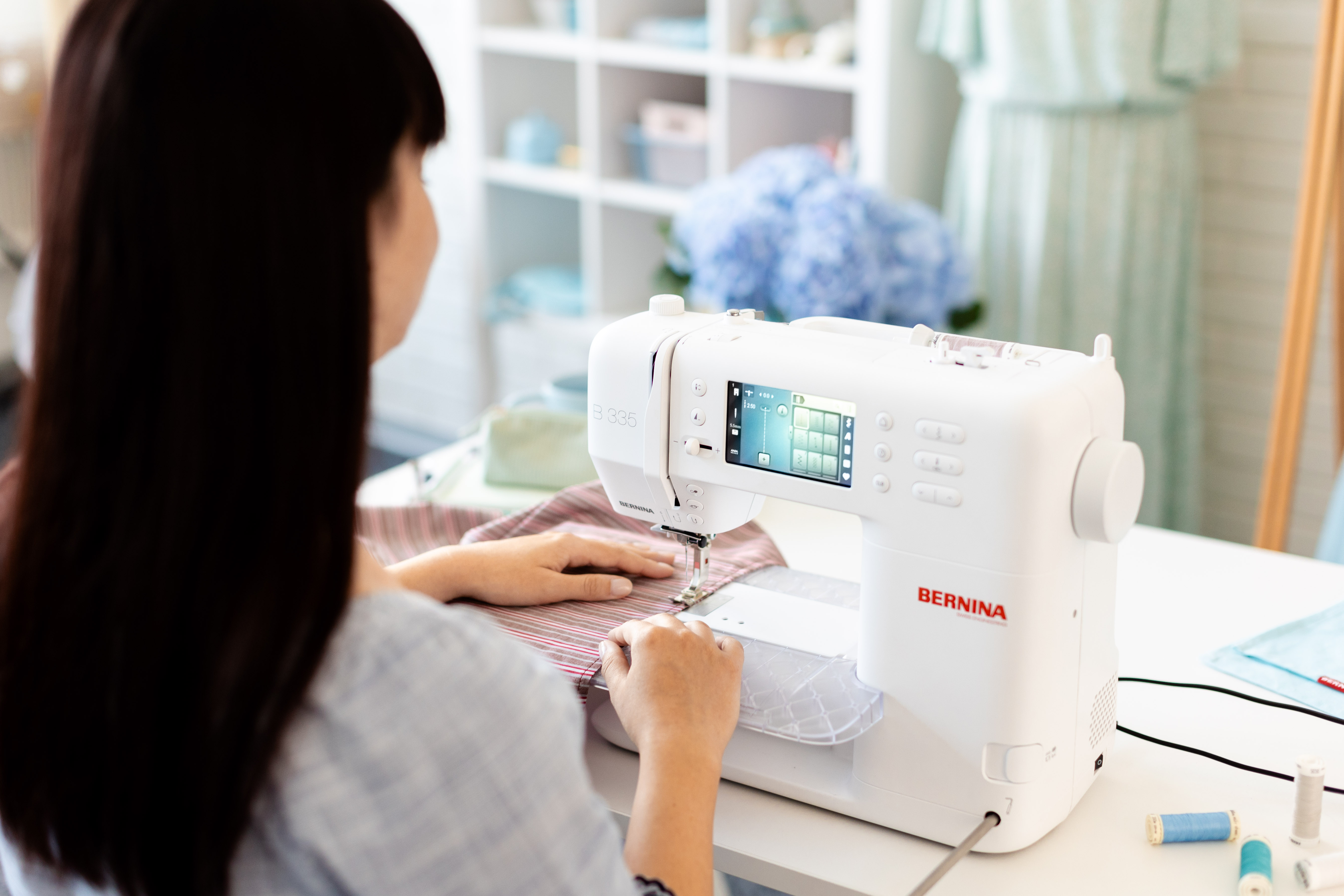 someone sewing on machine