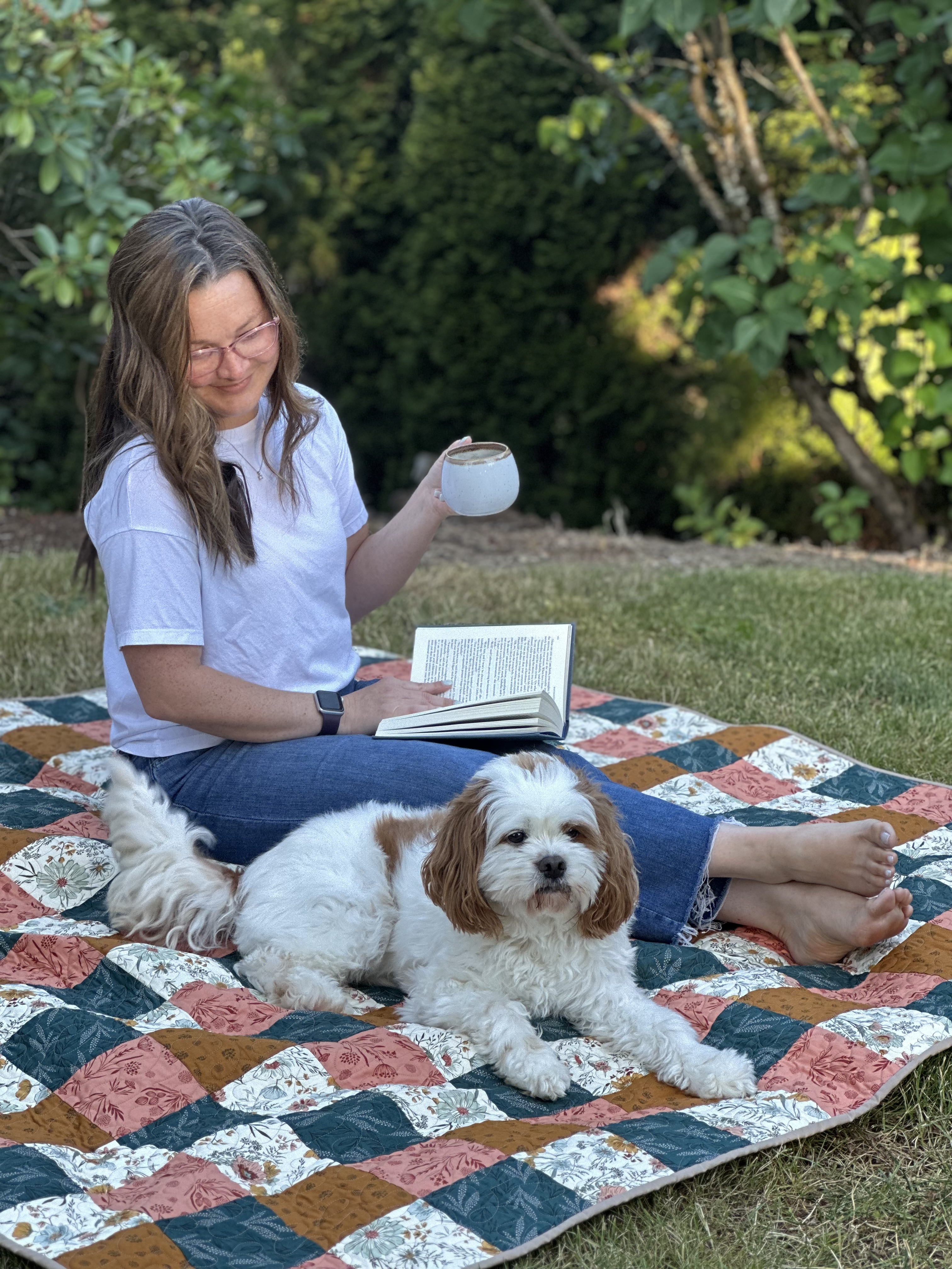 Mae Just Sew on a picnic blanket with her dog