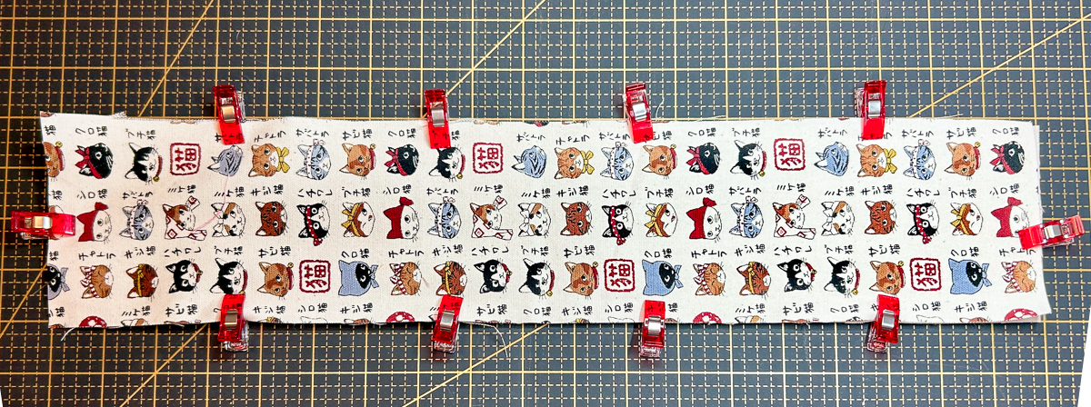 main fabric with right side up with red clips