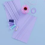 Purple fabric samples showing decorative stitching techniques with Cordonnet thread, alongside spools of colorful thread and a BERNINA presser foot