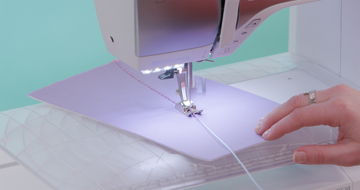 BERNINA 480 sewing machine couching variegated cord onto purple fabric using Cordonnet Foot #11