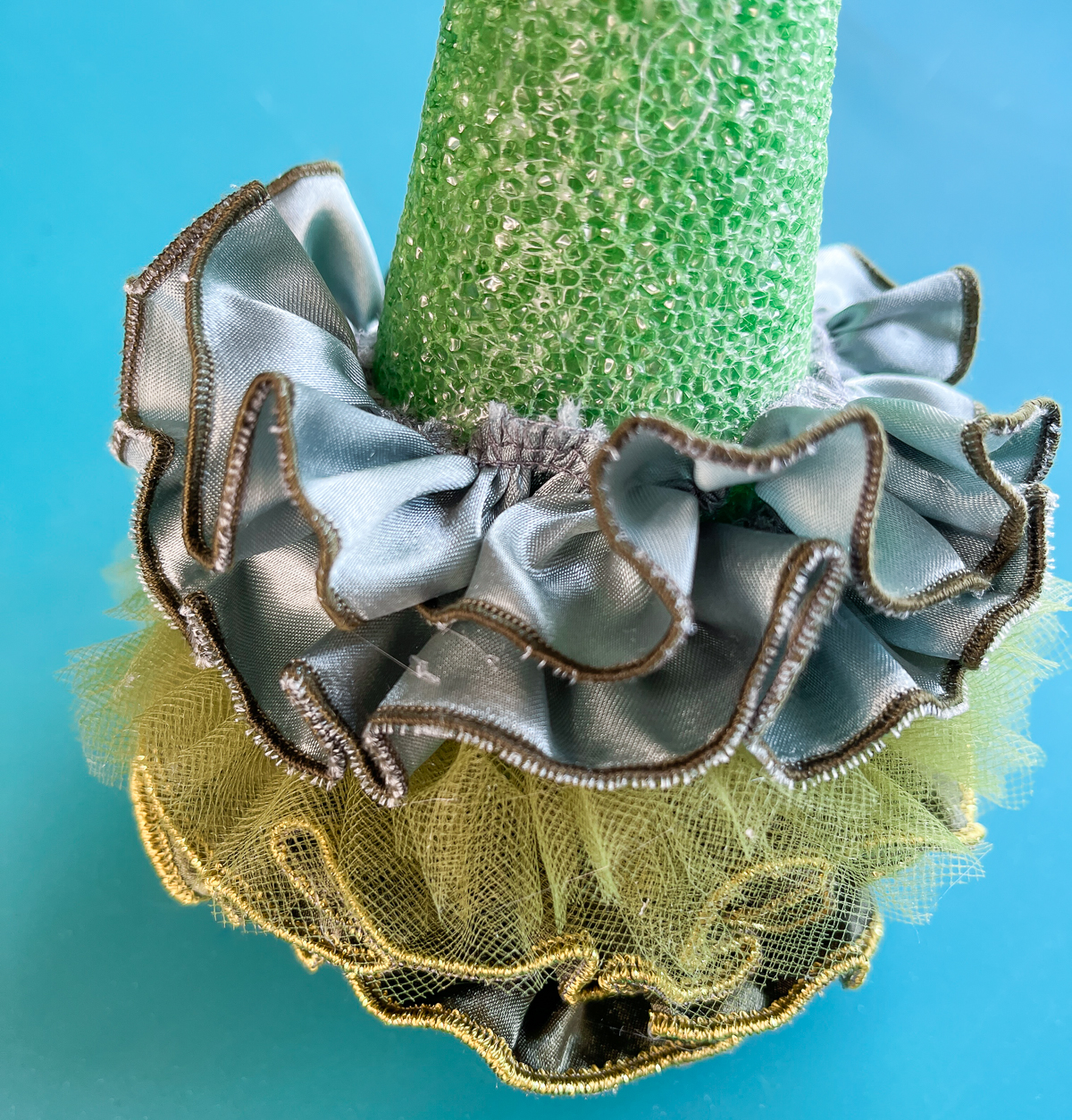 fabric strips around green cone