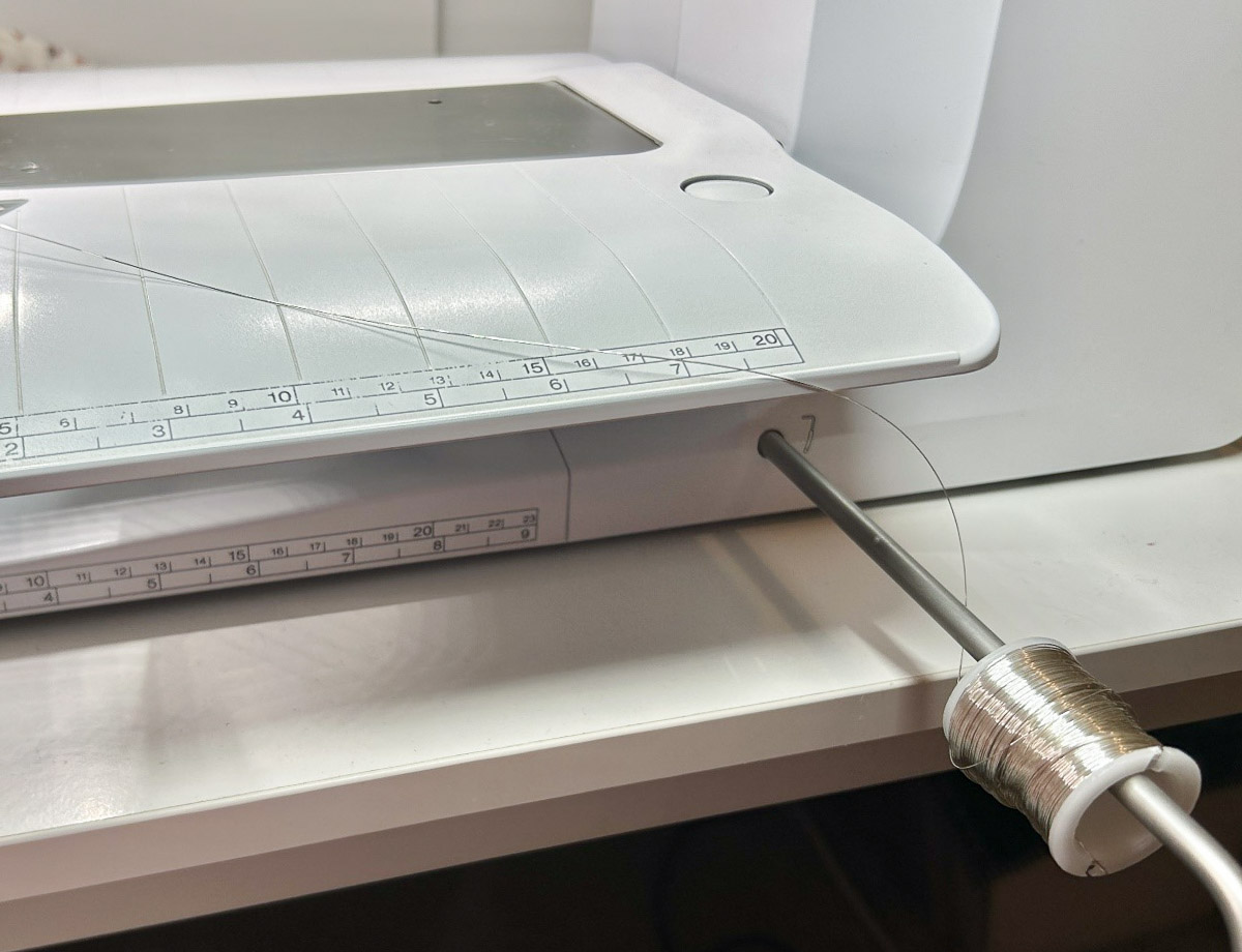 close up of a spool of wire attached to the BERNINA Free Hand System.