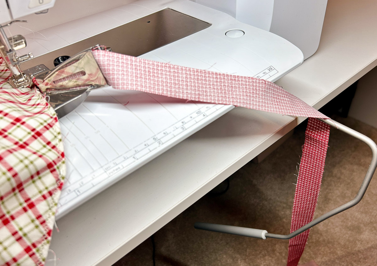 red binding fabric draped over the BERNINA Free Hand System.